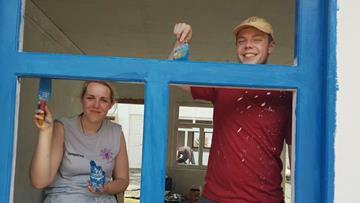 Helping paint the building