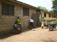 Cadets plastering the outer wall of the school in Ghana
